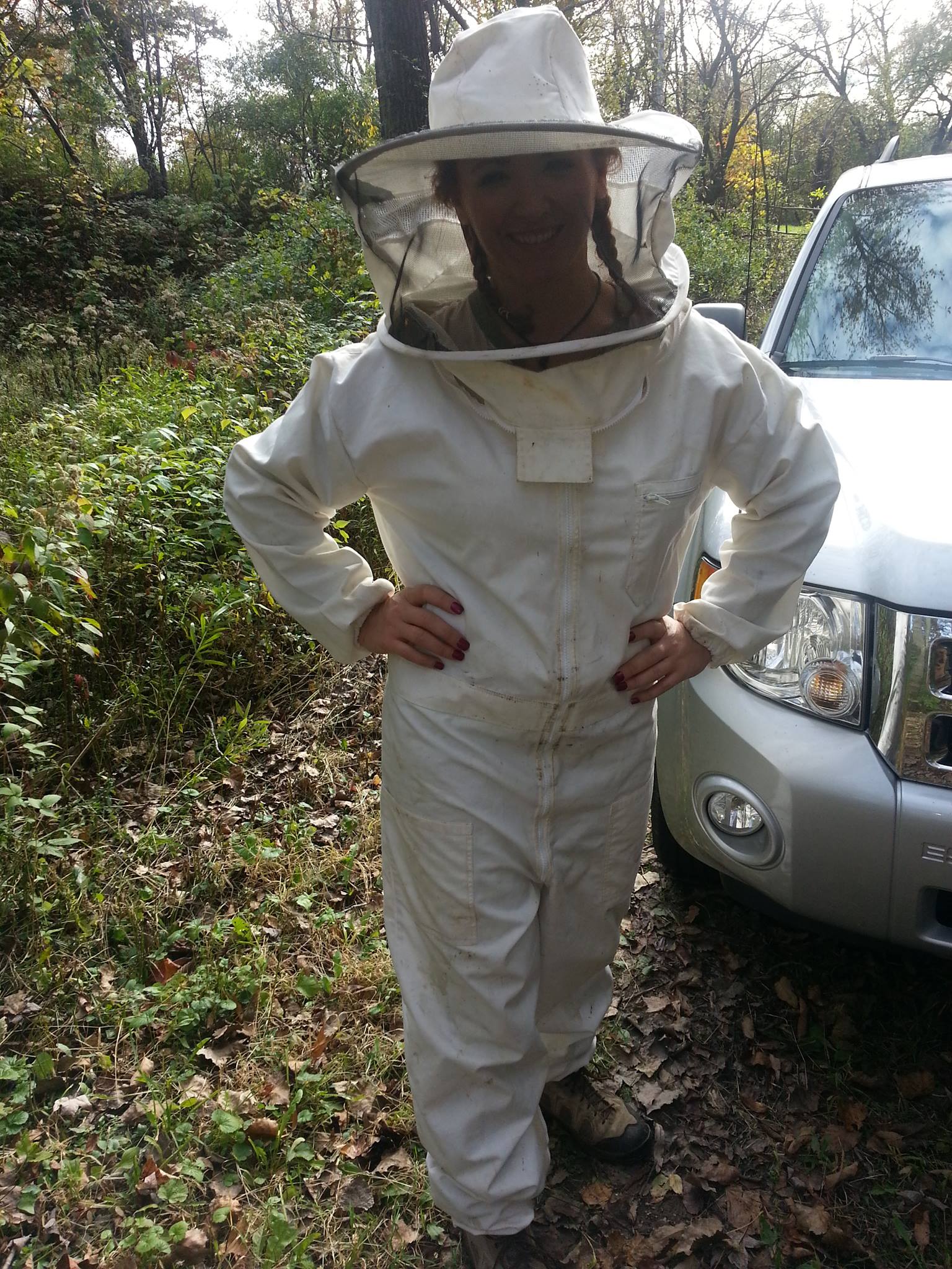 Beekeeper in protective suit at the hives